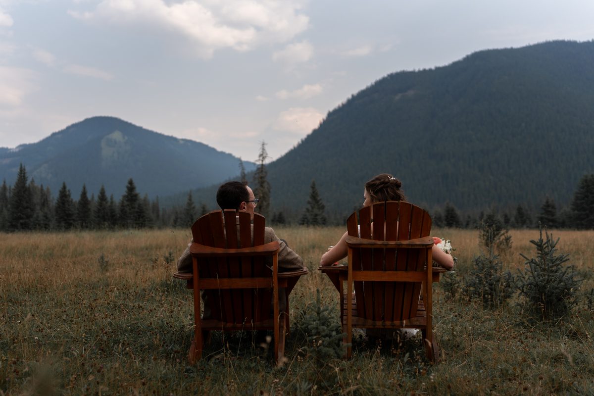 Two chairs looking out over a Rockies mountain lake